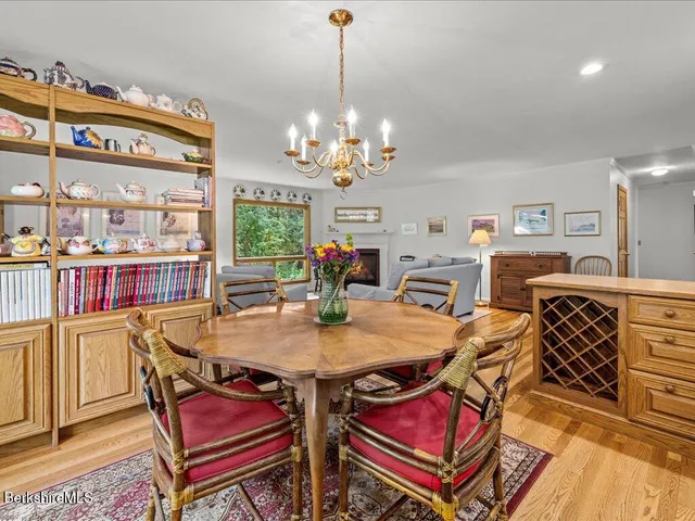 a view of a dining room with furniture a chandelier and wooden floor
