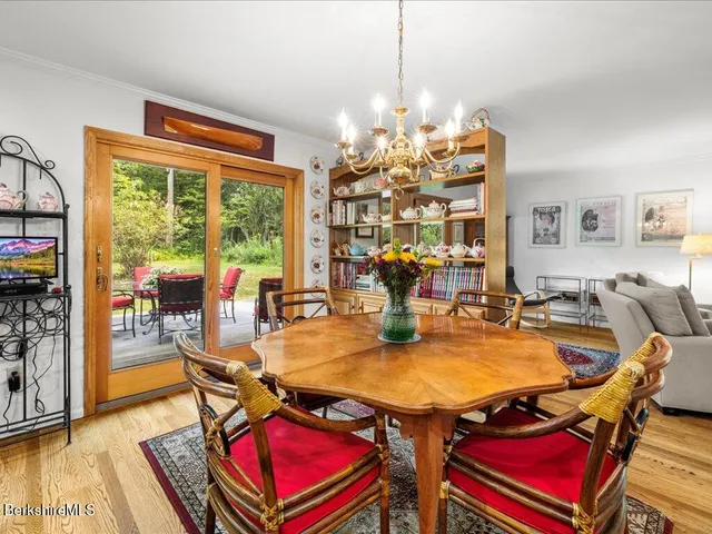 a view of a dining room with furniture wooden floor and a chandelier