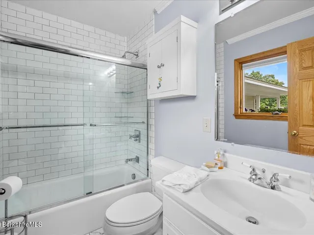 a bathroom with a sink mirror bathtub and toilet