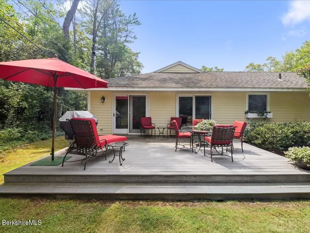 a view of swimming pool with table and chairs under an umbrella