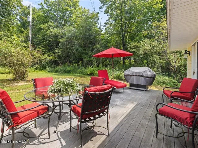 an outdoor sitting area with furniture and wooden deck