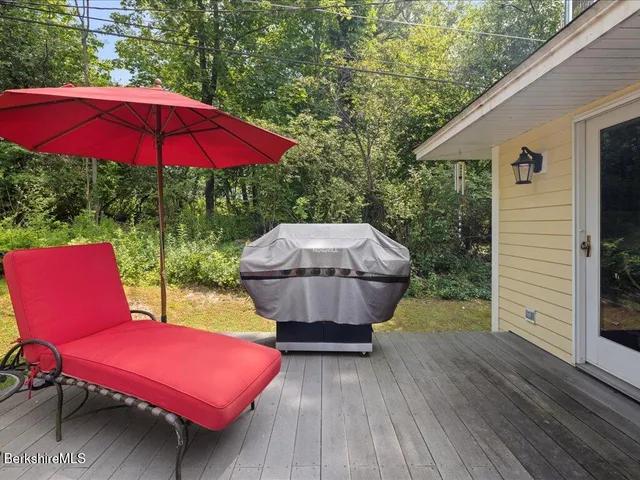 a view of backyard of house with wooden floor