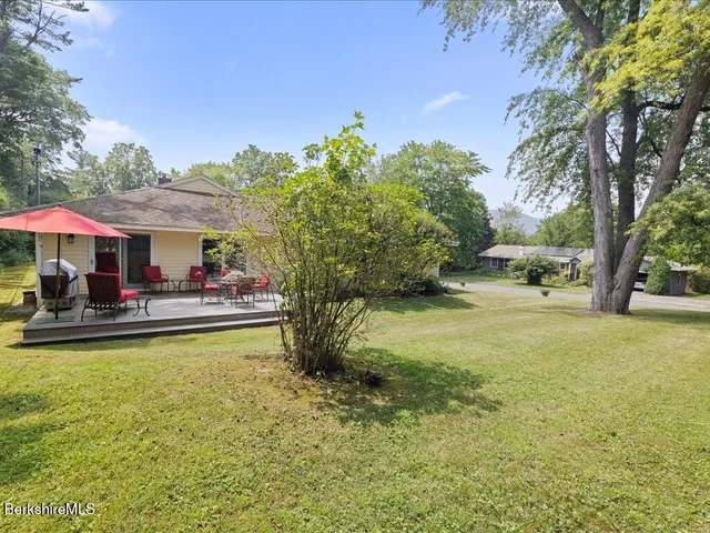an aerial view of a house with yard swimming pool and outdoor seating