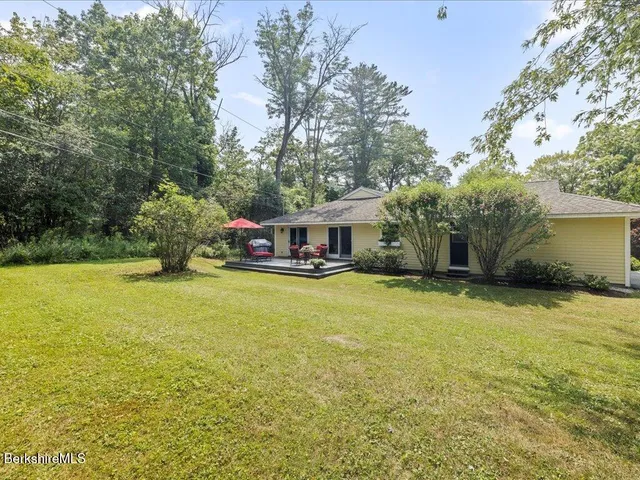 an aerial view of a house with swimming pool and garden