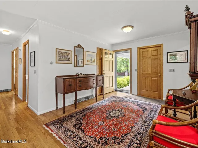 a living room with furniture rug and a window