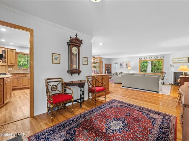 a living room with furniture a rug and a table