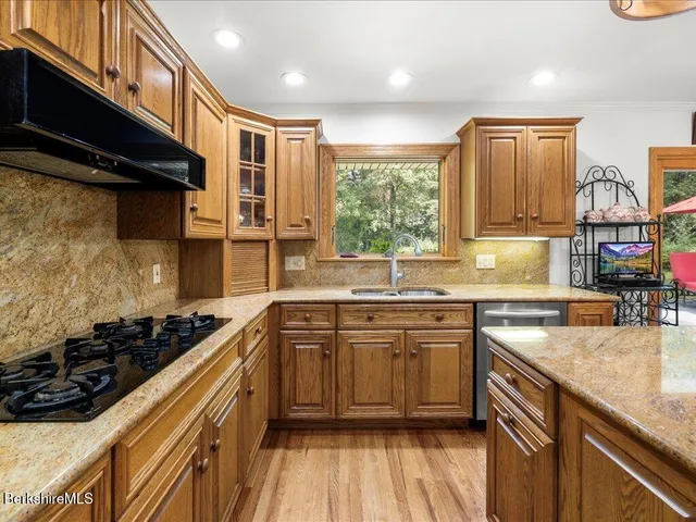 a kitchen with a sink stove top oven and cabinets