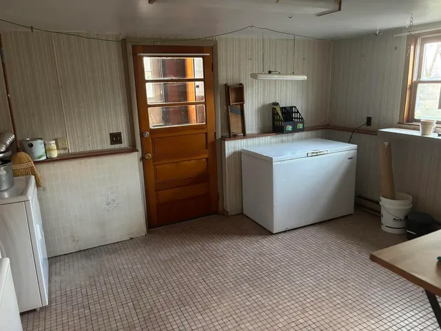 a kitchen with counter top space and wooden floor