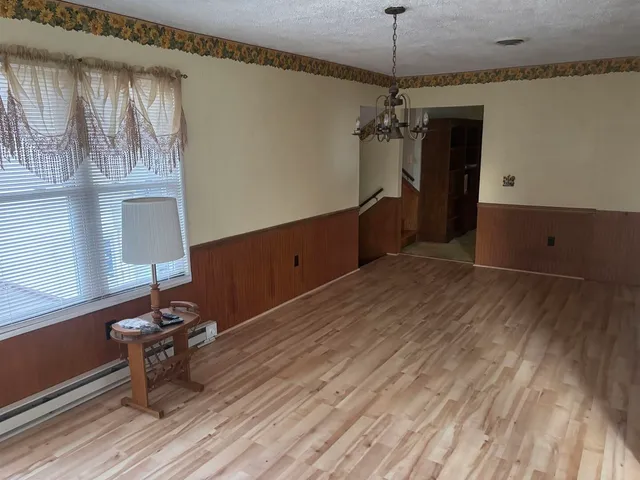 a room with a window and furniture