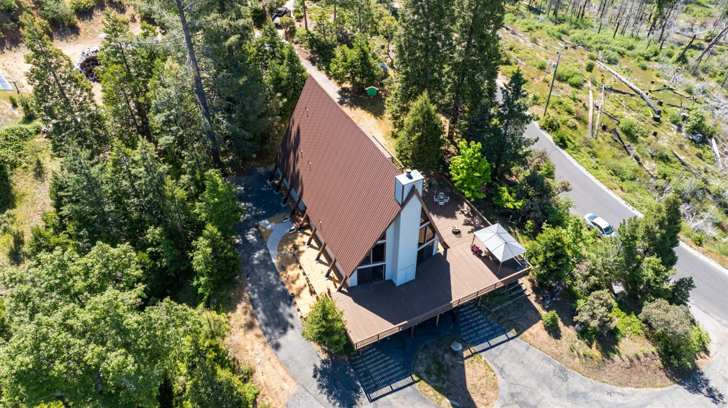 38303 Woodland Road Shaver Lake, CA 93664 - Photo 3 of 28 an aerial view of a house with a yard and trees