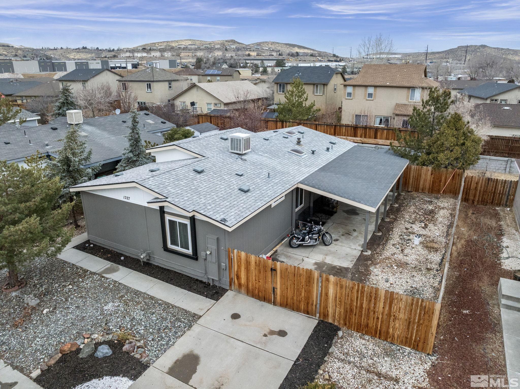 an aerial view of a house with a yard