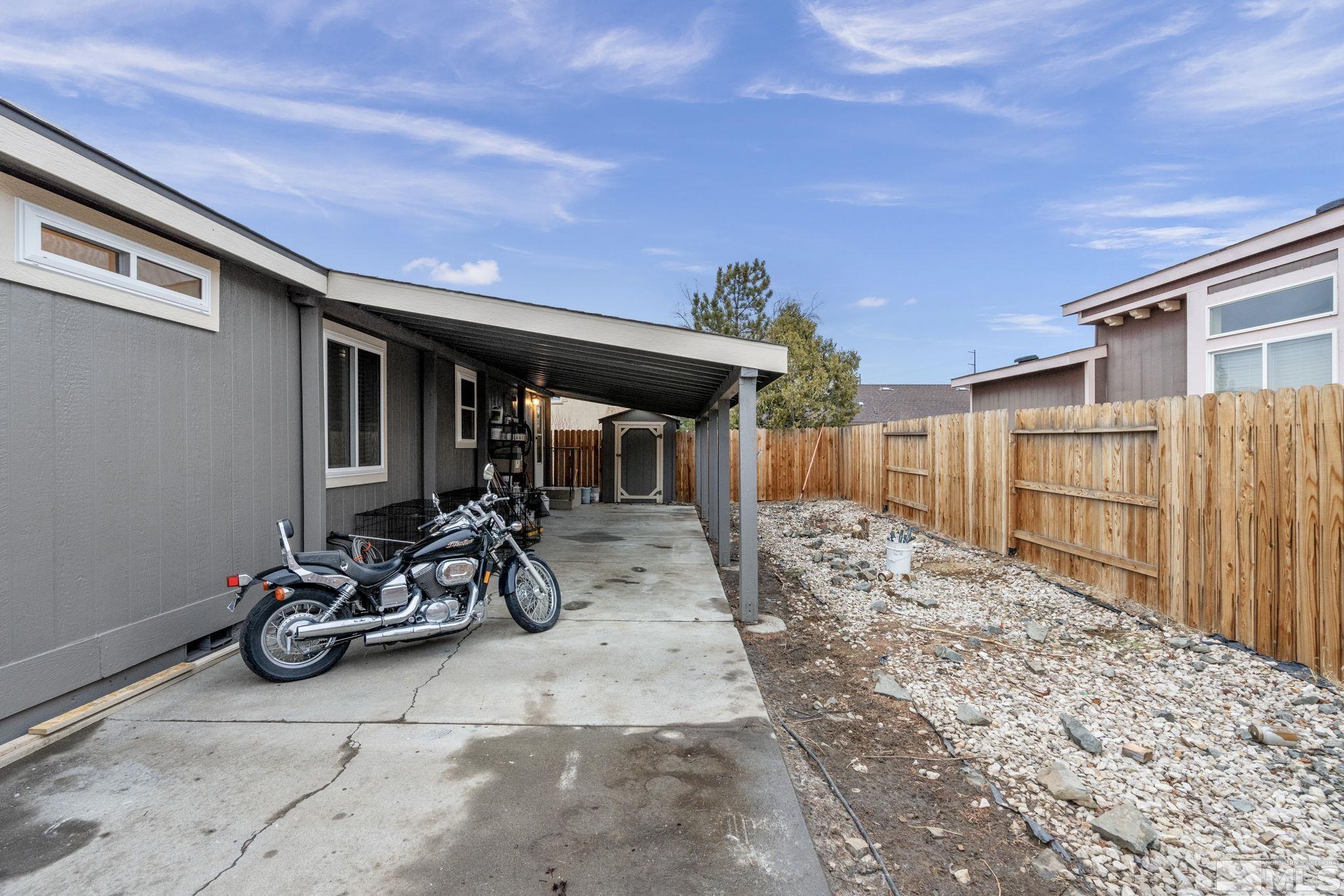 1327 Lynx Street Reno, NV 89506 - Photo 36 of 38 a view of a patio with table and chairs and wooden fence