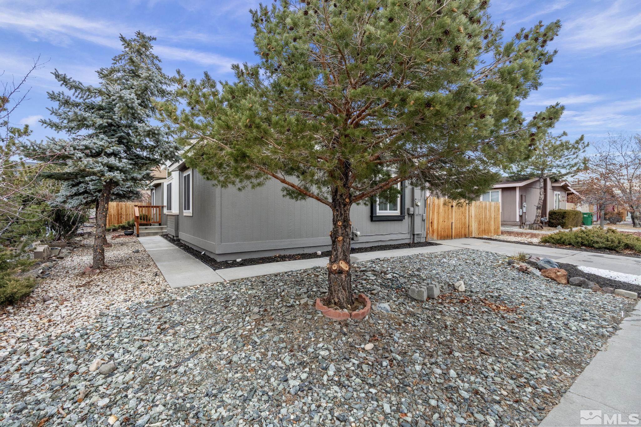 1327 Lynx Street Reno, NV 89506 - Photo 5 of 38 a backyard of a house with trees and outdoor seating