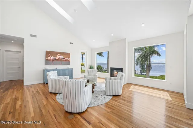 a view of a dining room with furniture wooden floor and chandelier
