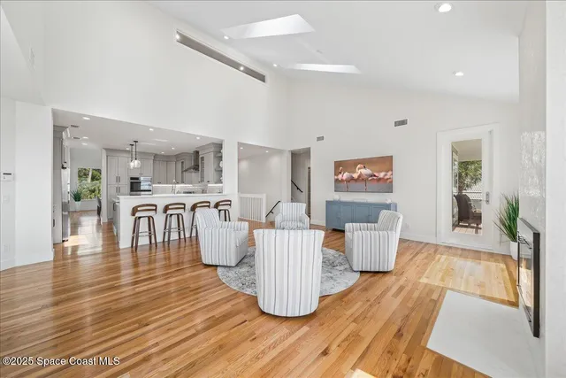 a large white kitchen with lots of counter space wooden floor and appliances