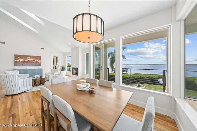 a kitchen with stainless steel appliances granite countertop a sink a stove a refrigerator and island with wooden floor