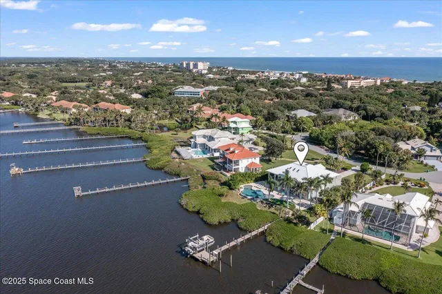 an aerial view of a house with a garden and lake view