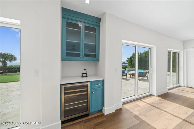 a view of a chairs and table in patio with a swimming pool