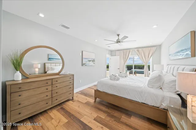 a view of a patio with lawn chairs wooden floor and fence