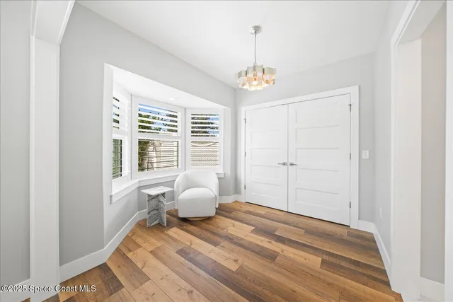 a view of a patio with table and chairs potted plants with wooden floor
