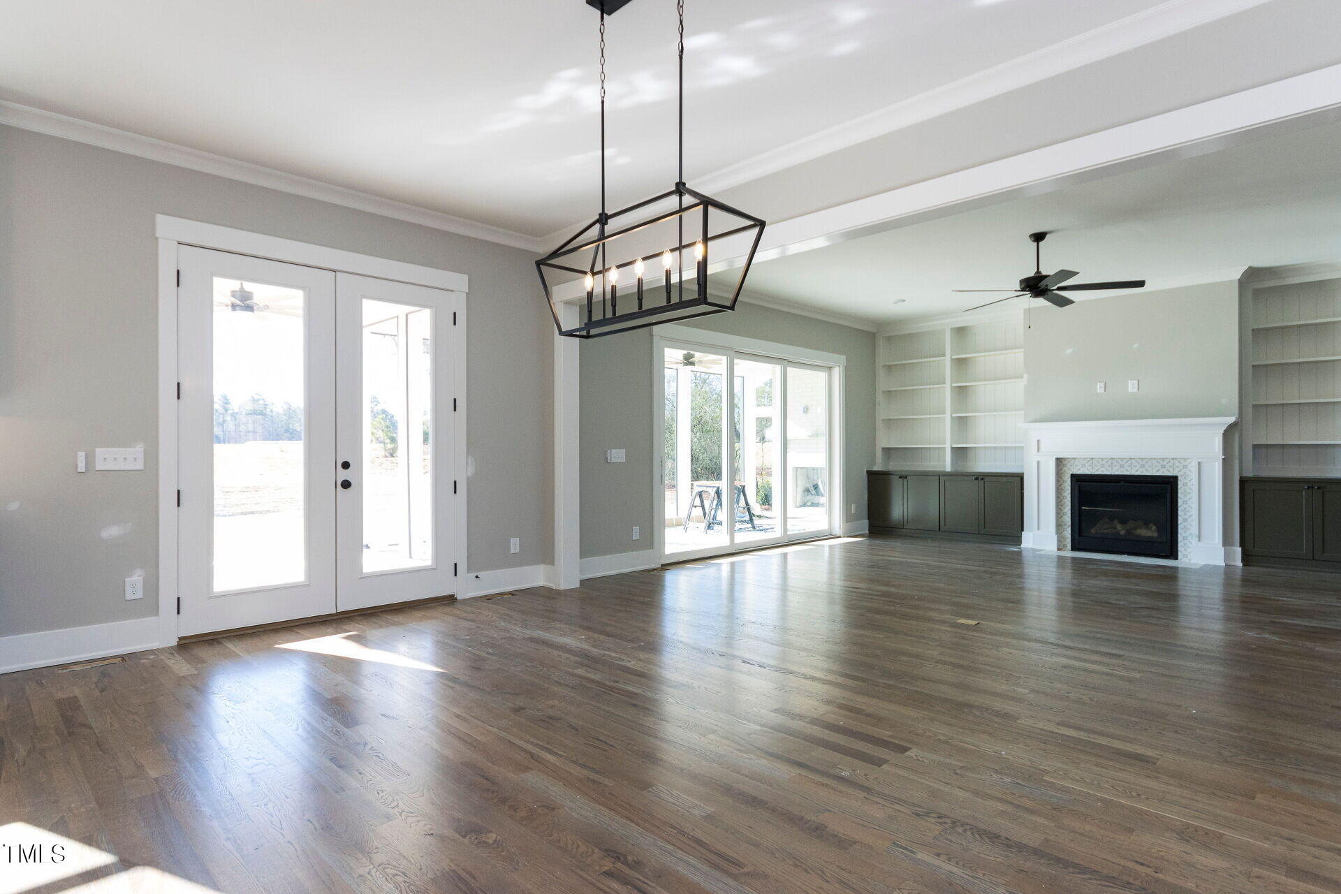 155 Gaines Trail Pittsboro, NC 27312 - Photo 38 of 86 a view of an empty room with wooden floor fireplace and a window