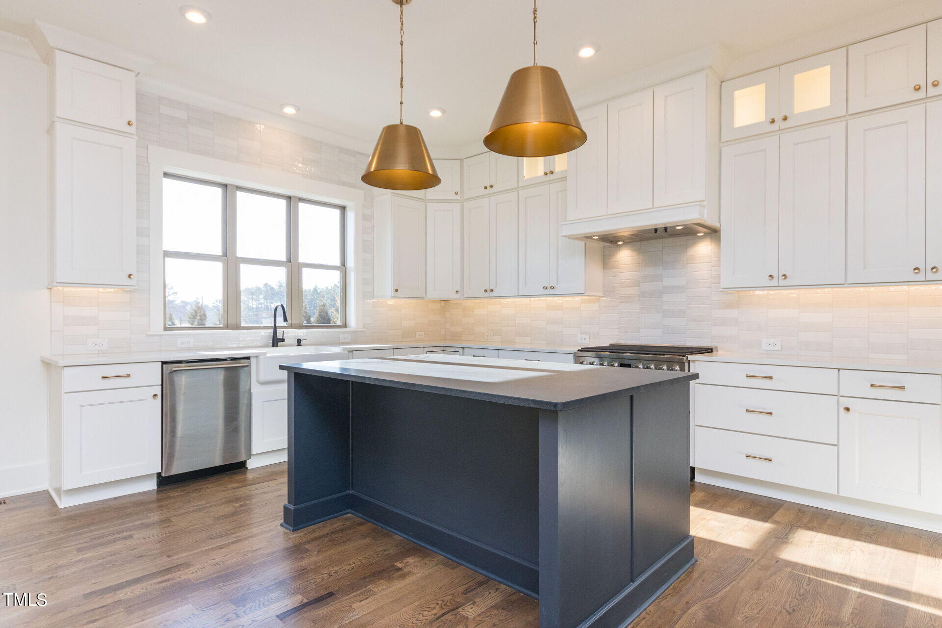 155 Gaines Trail Pittsboro, NC 27312 - Photo 44 of 86 a kitchen with stainless steel appliances granite countertop a sink a stove and wooden floors