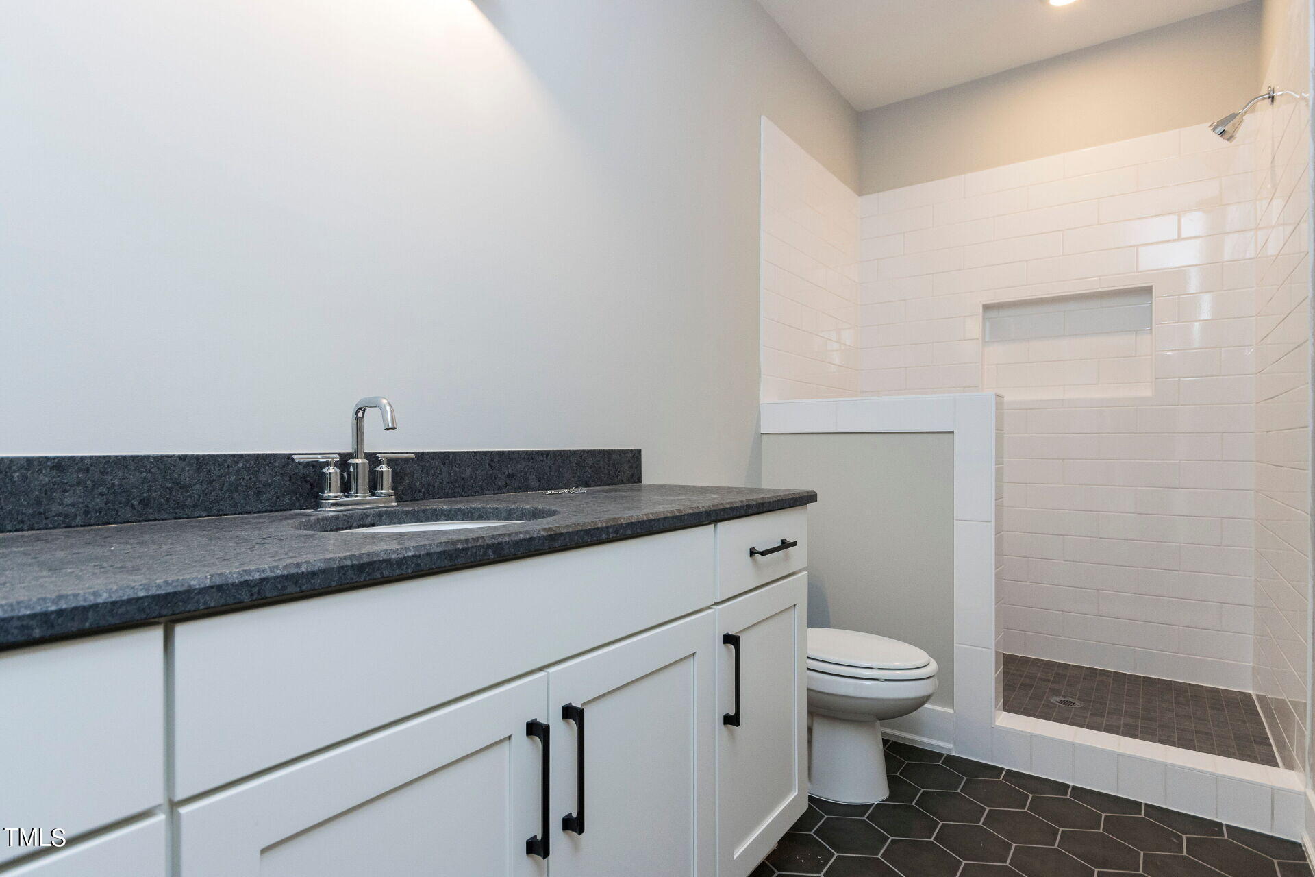155 Gaines Trail Pittsboro, NC 27312 - Photo 54 of 86 a bathroom with a granite countertop sink a toilet and a mirror