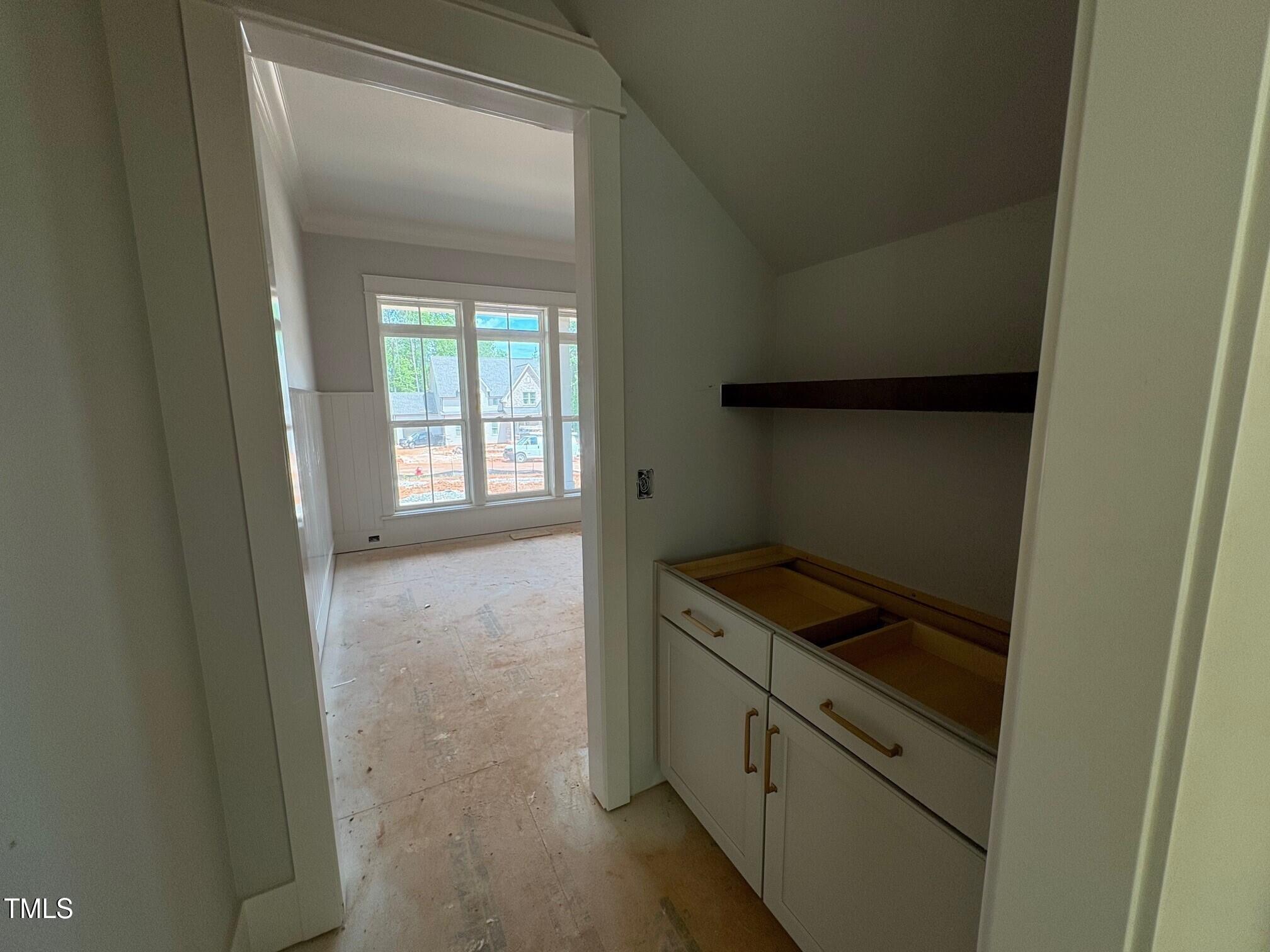 155 Gaines Trail Pittsboro, NC 27312 - Photo 67 of 86 a kitchen with white cabinets and white appliances
