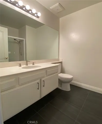 a bathroom with a double vanity sink and a toilet