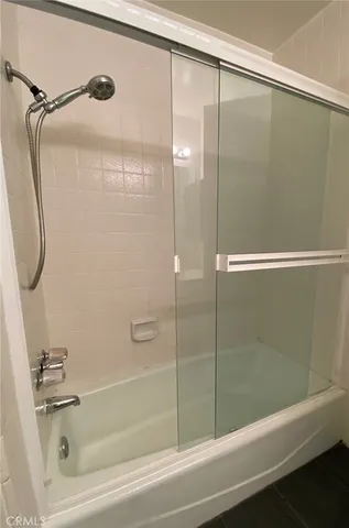 a bathroom with a shower and a bathtub
