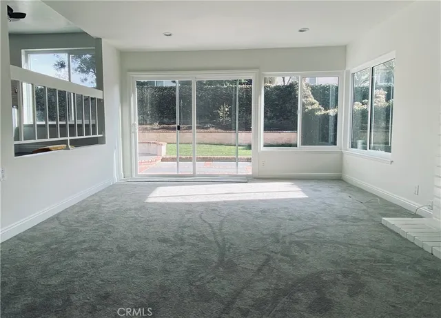 a view of an empty room with a large window