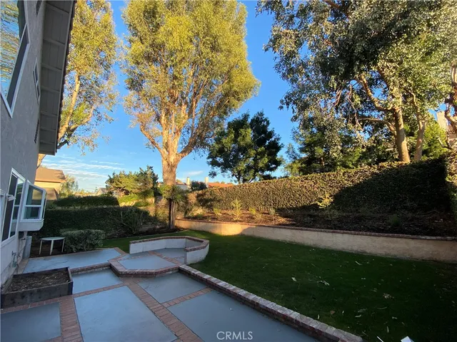 a view of a house with backyard porch and sitting area