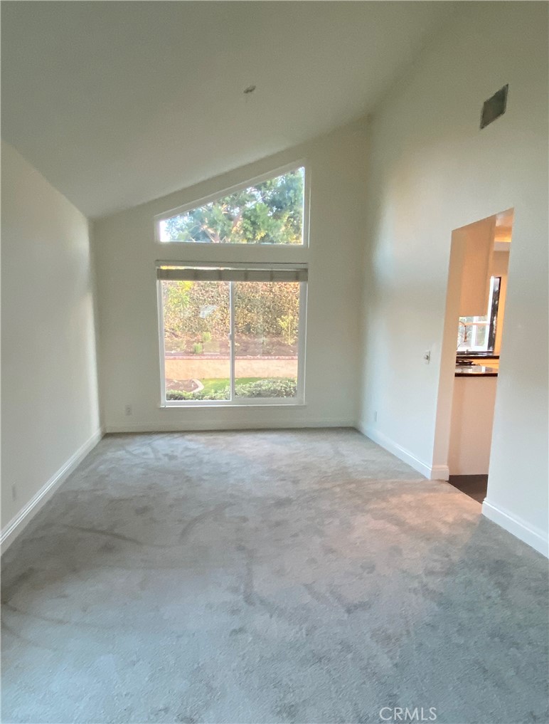 43 Fortuna Irvine, CA 92620 - Photo 7 of 26 an empty room with windows and an outdoor view