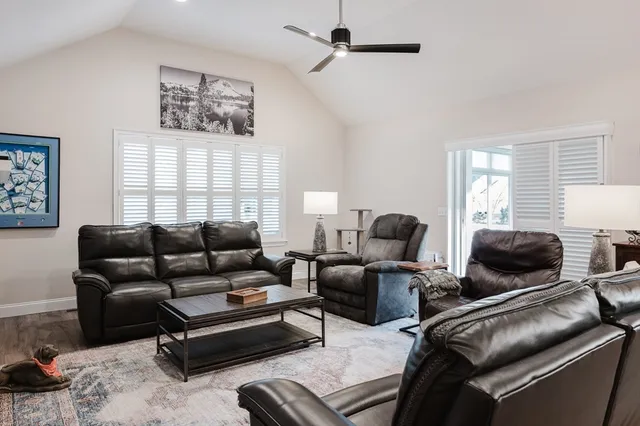a living room with furniture a fireplace and a flat screen tv