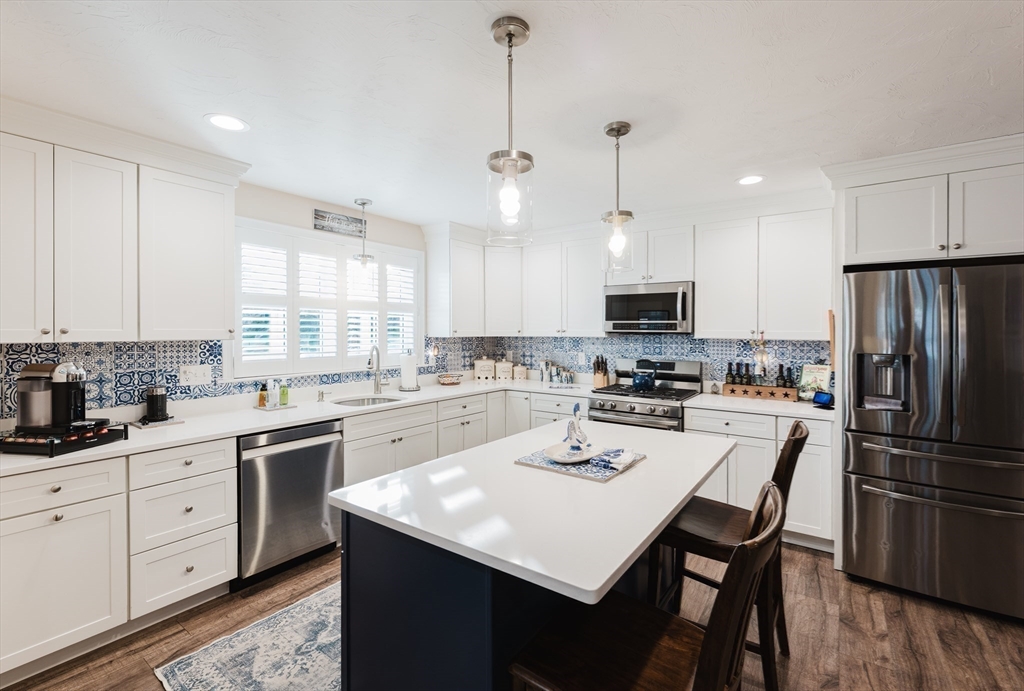 4 Sarah Beth Lane, Unit 1 Wareham, MA 02571 - Photo 23 of 42 a kitchen with a white center island and cabinets
