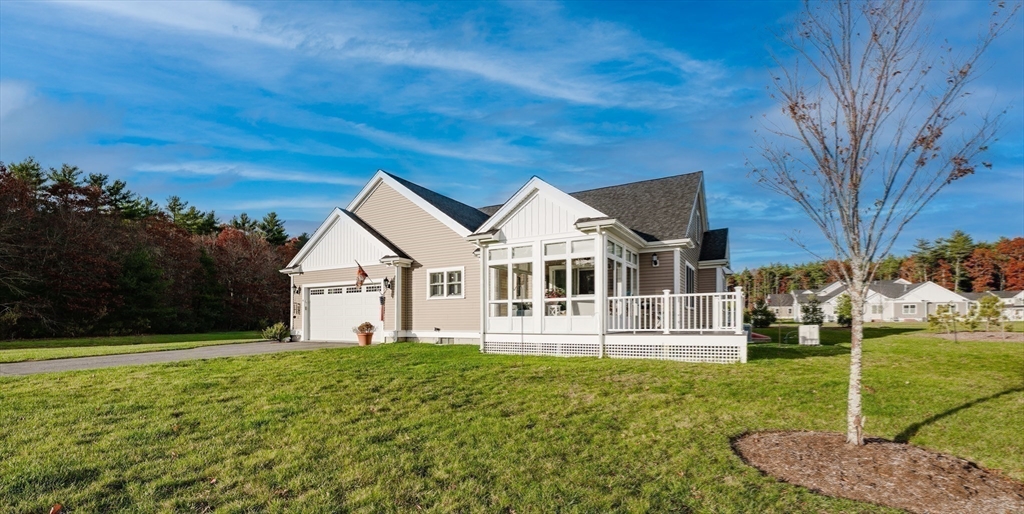4 Sarah Beth Lane, Unit 1 Wareham, MA 02571 - Photo 5 of 42 a front view of a house with a yard