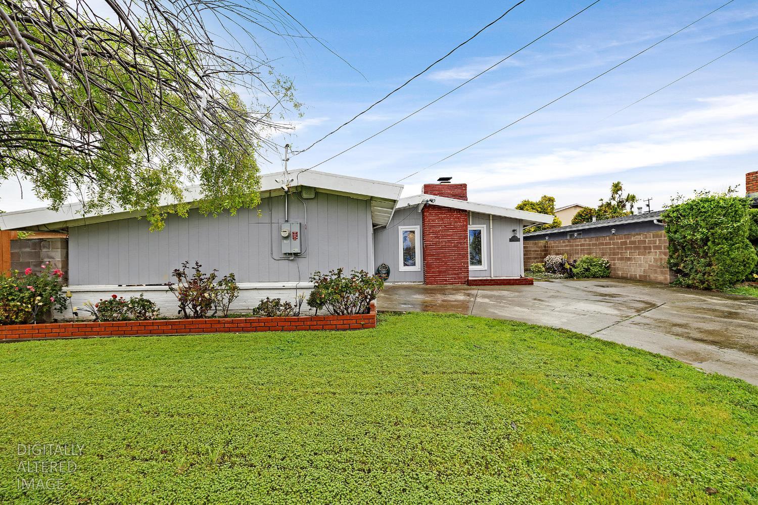 a front view of house with yard and a garden