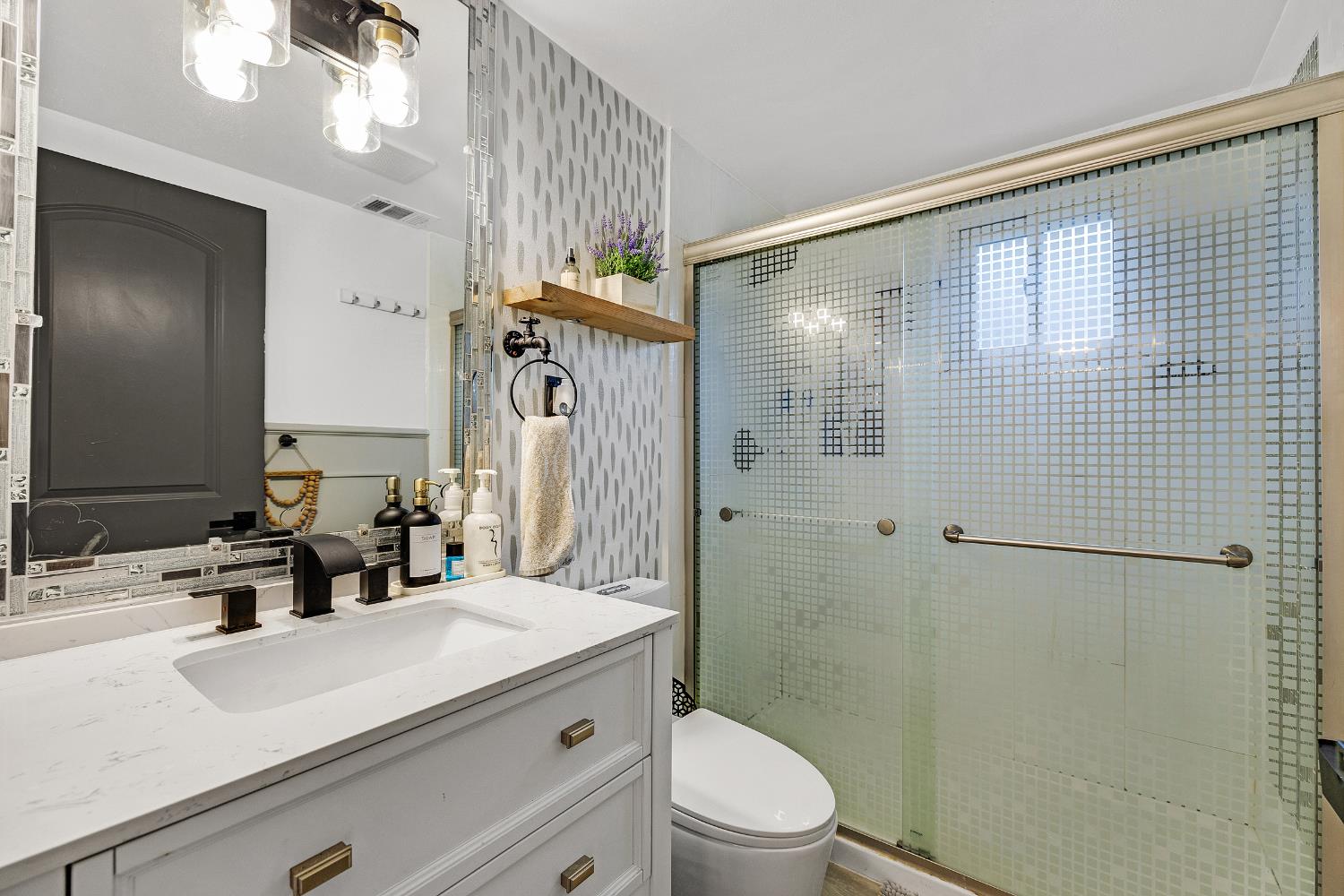 1481 Rieger Avenue Hayward, CA 94544 - Photo 23 of 34 a bathroom with a sink a toilet a mirror and shower