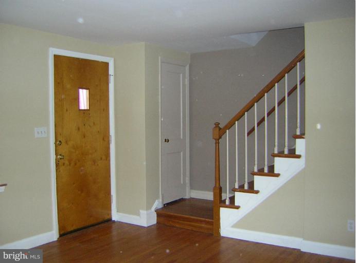 1677 Thetford Road Towson, MD 21286 - Photo 2 of 18 a view of entryway with wooden floor and stairs