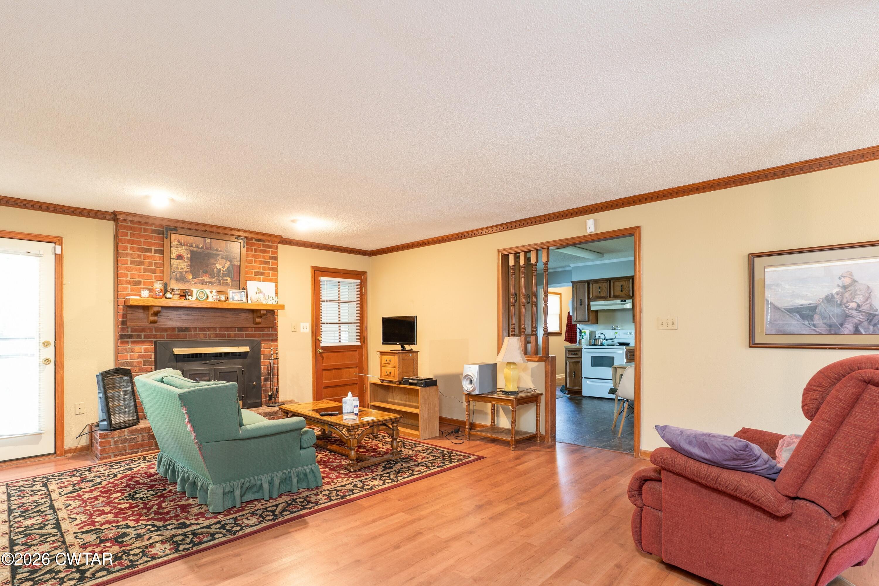 1053 Ashport Road Jackson, TN 38305 - Photo 19 of 42 a living room with furniture large windows and wooden floor