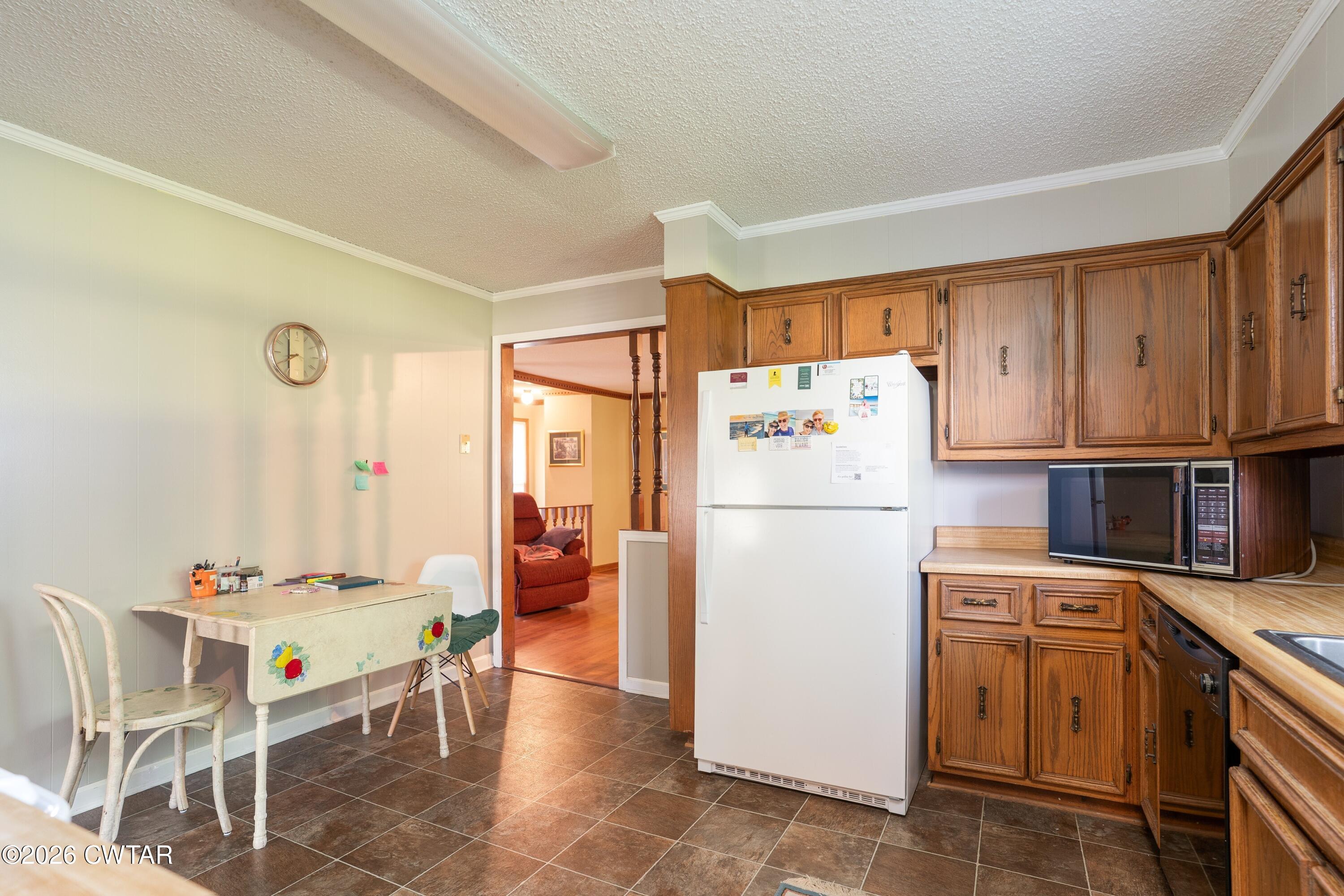 1053 Ashport Road Jackson, TN 38305 - Photo 26 of 42 a white refrigerator freezer sitting in a kitchen with stainless steel appliances granite countertop a refrigerator and a stove top oven