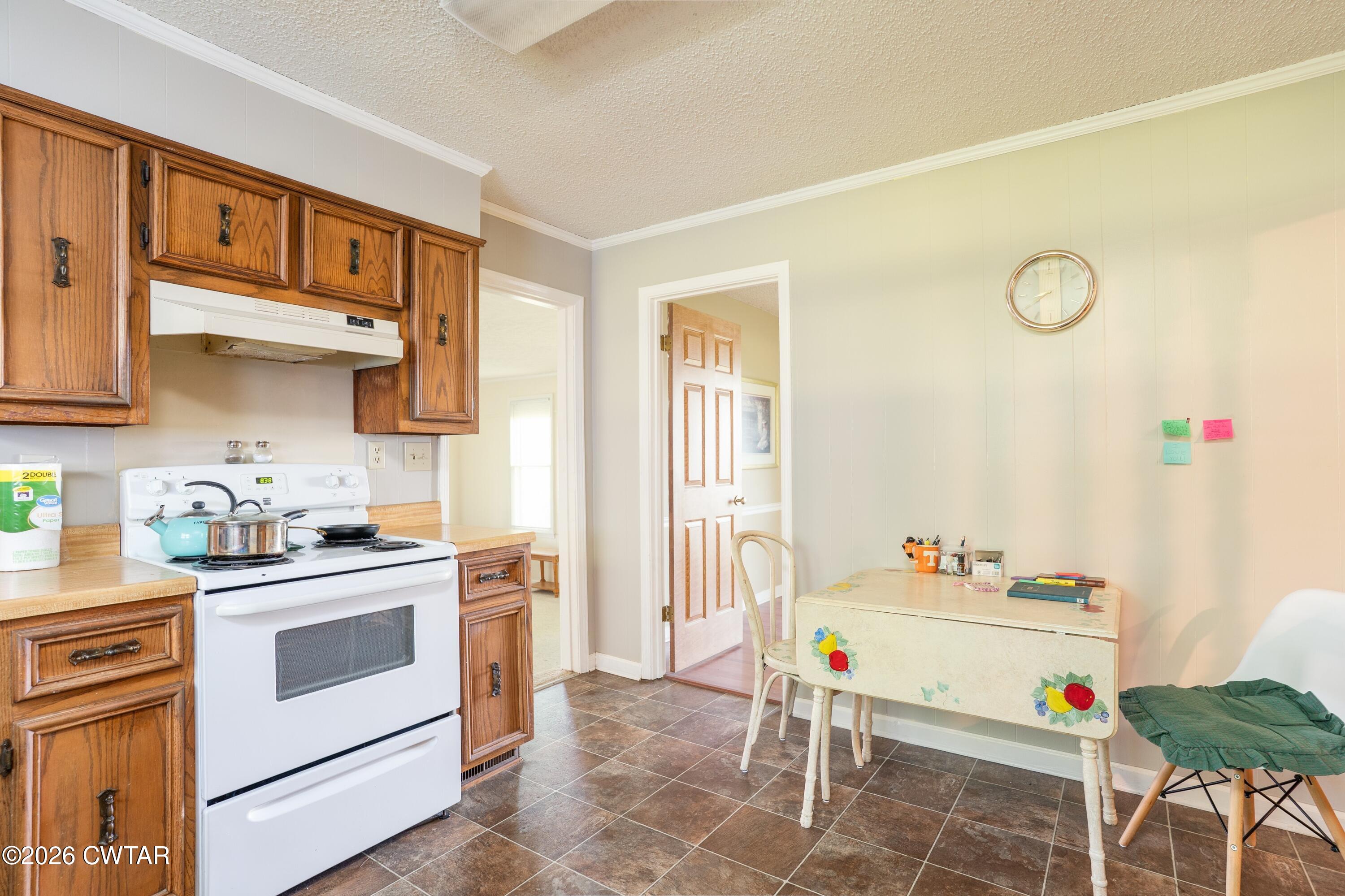 1053 Ashport Road Jackson, TN 38305 - Photo 27 of 42 a kitchen with a sink a stove and cabinets