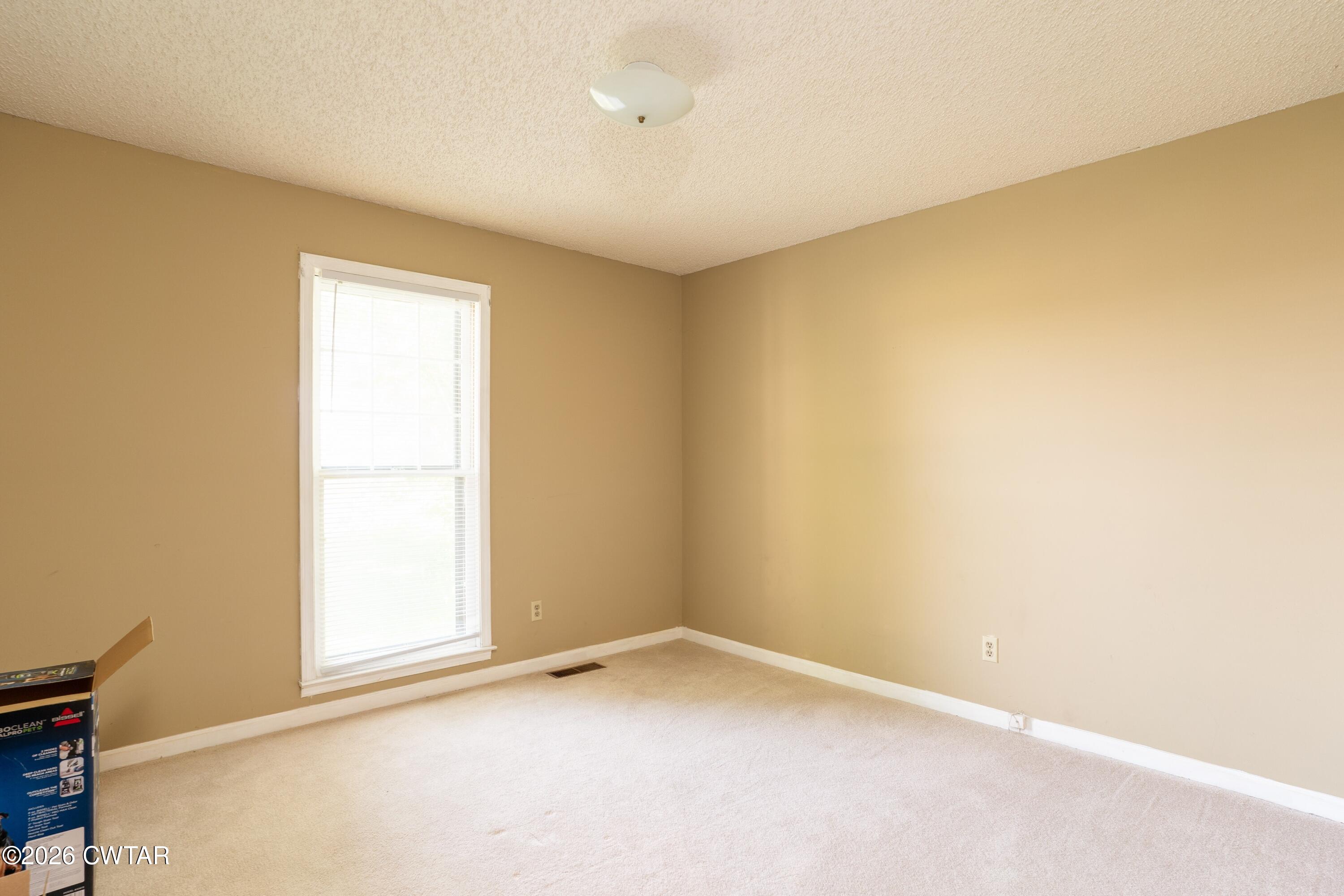 1053 Ashport Road Jackson, TN 38305 - Photo 30 of 42 an empty room with a empty space and a window