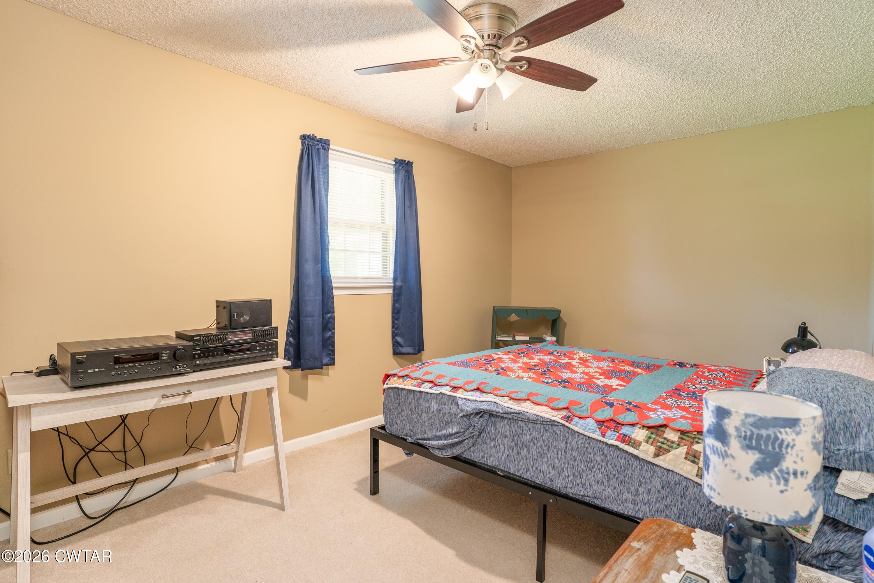1053 Ashport Road Jackson, TN 38305 - Photo 34 of 42 a bedroom with a bed and a chandelier