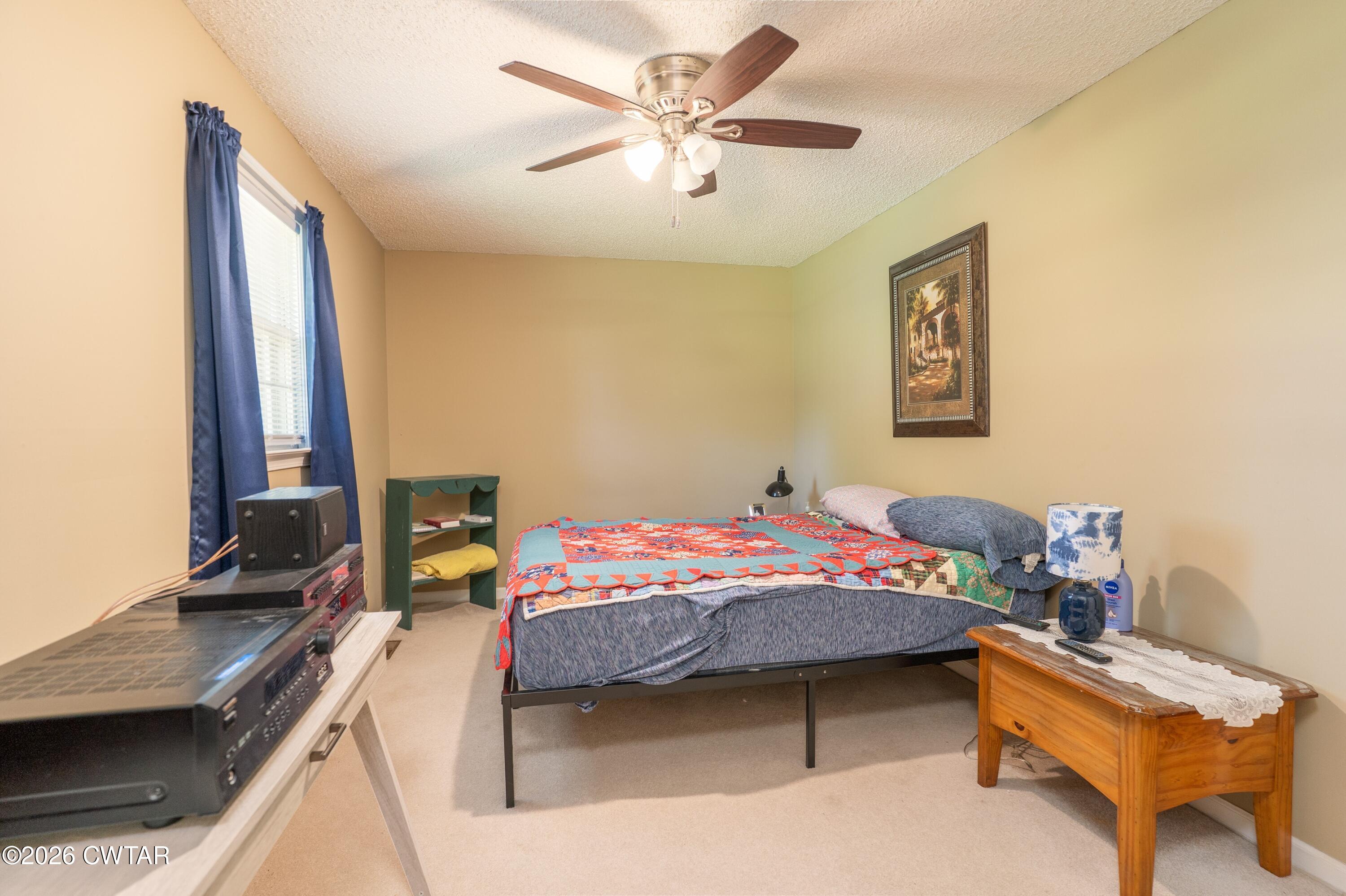 1053 Ashport Road Jackson, TN 38305 - Photo 35 of 42 a bedroom that has a bed and a chair in it