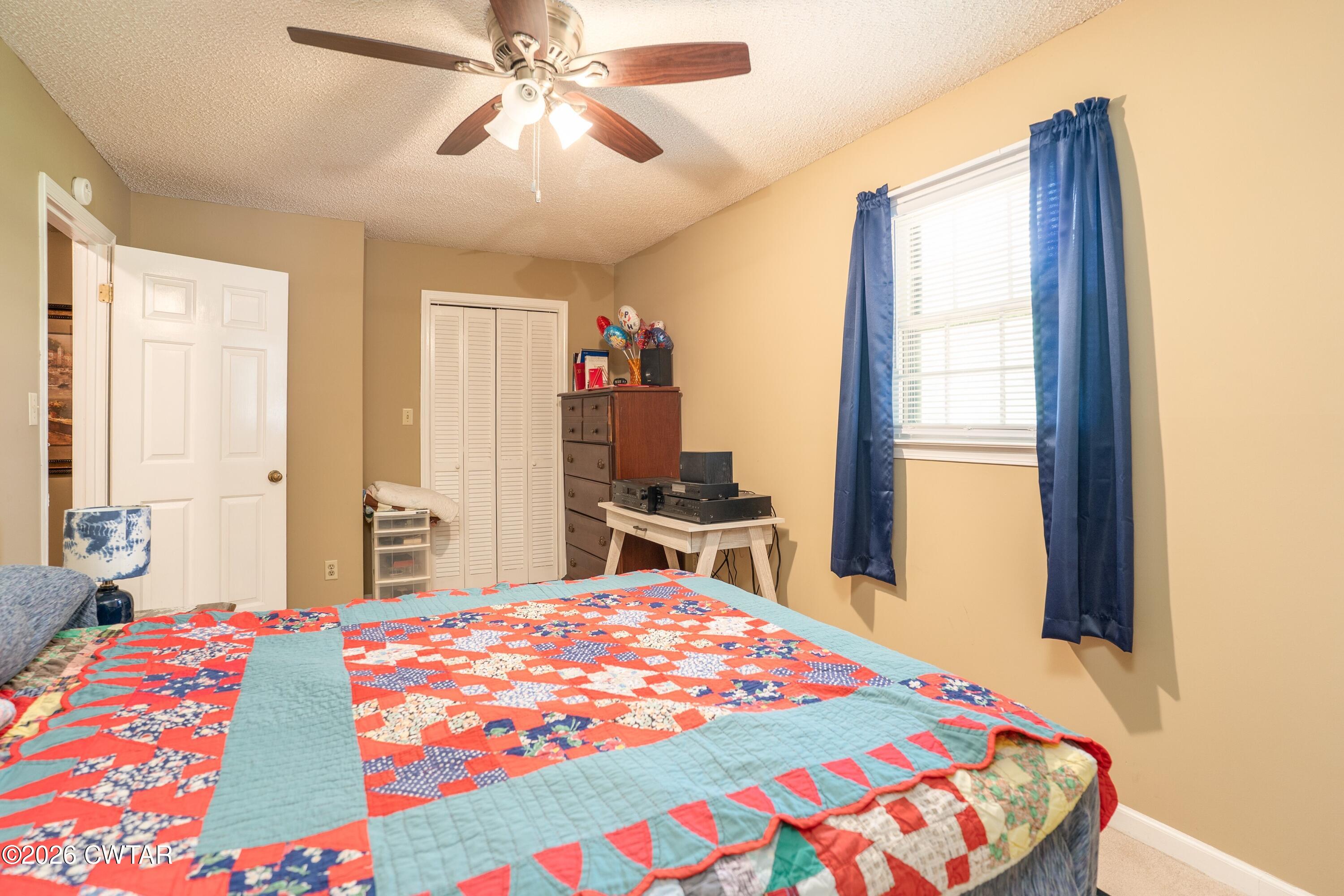 1053 Ashport Road Jackson, TN 38305 - Photo 36 of 42 a bedroom with a bed and a chandelier