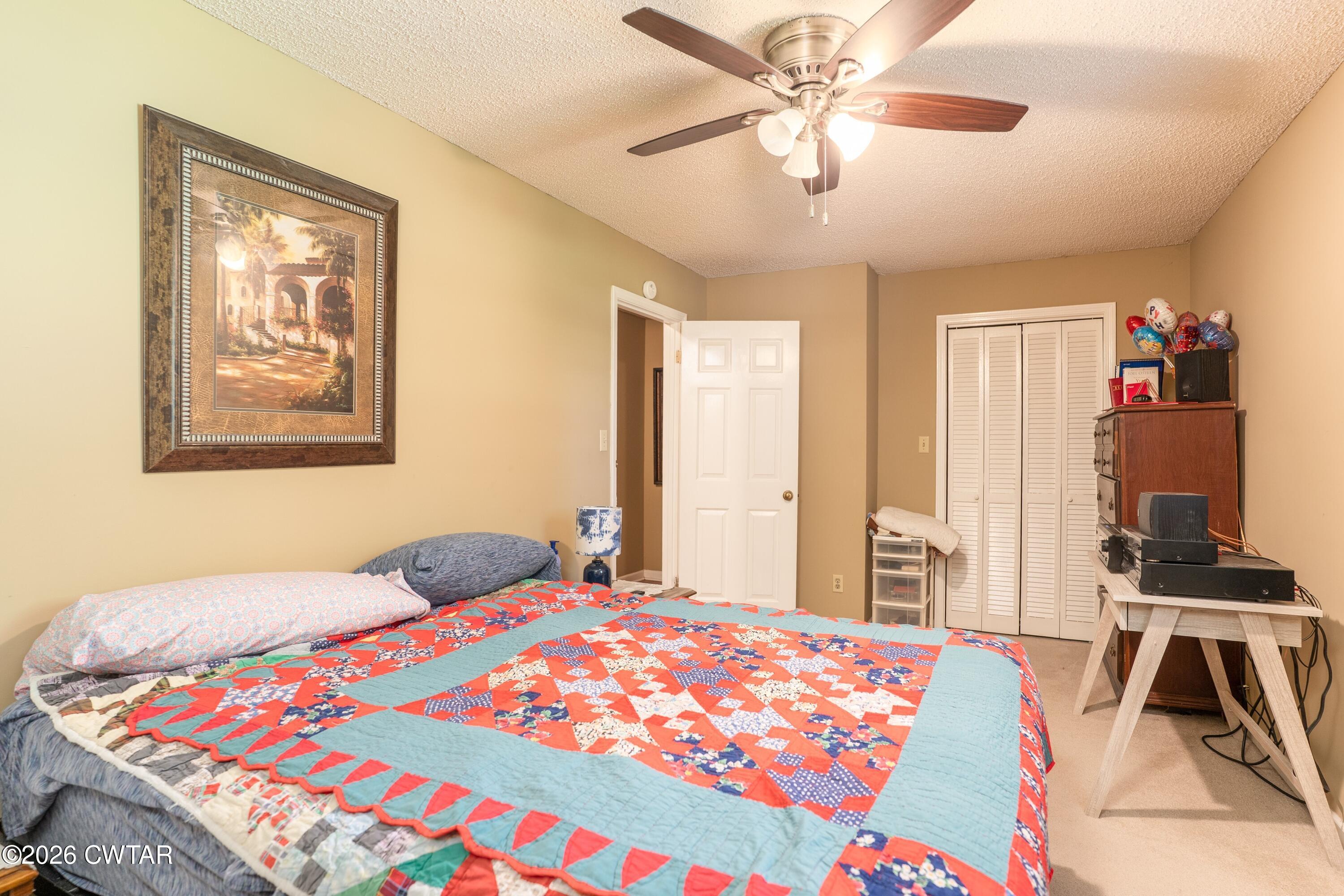 1053 Ashport Road Jackson, TN 38305 - Photo 37 of 42 a bedroom with a bed and a chandelier