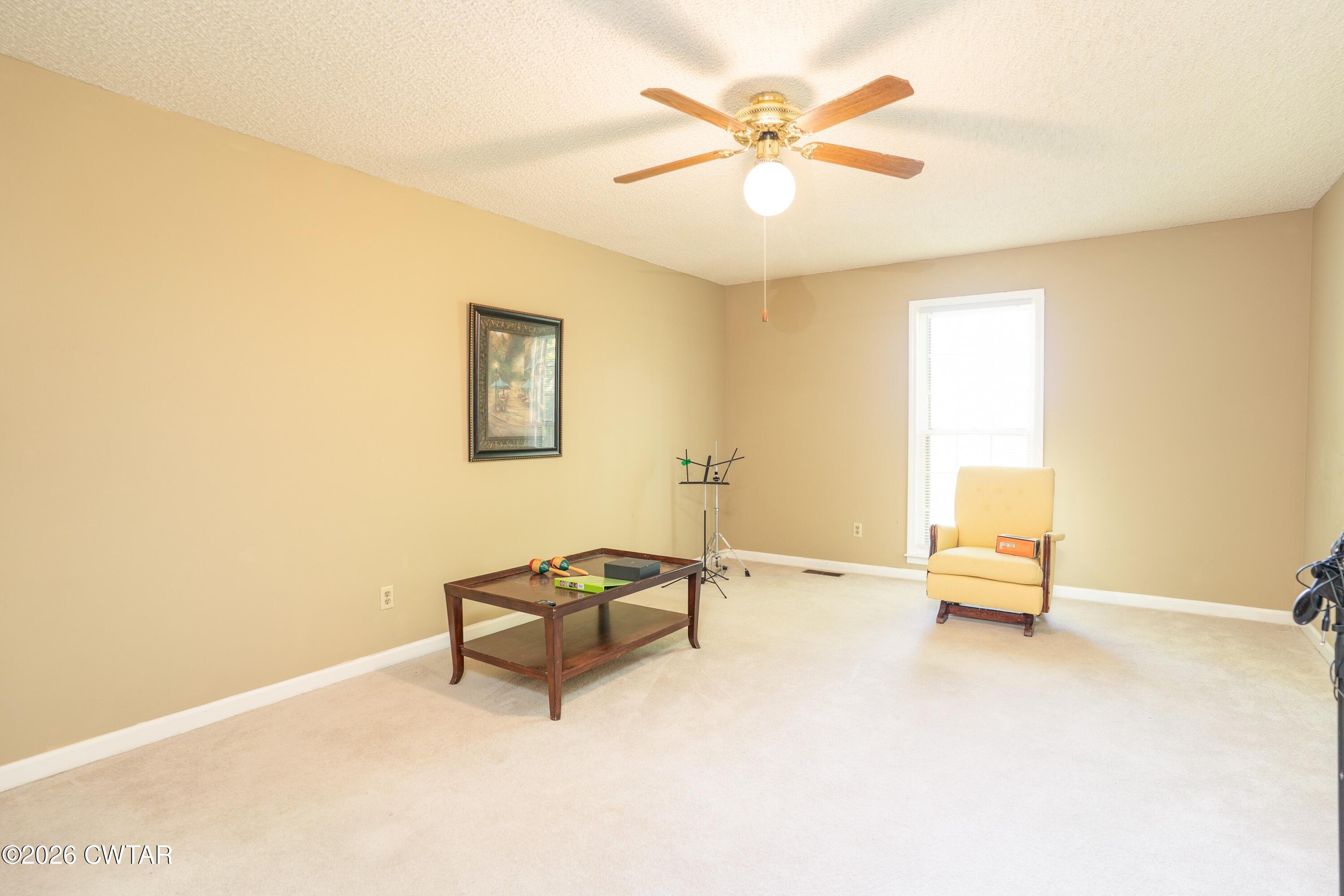 1053 Ashport Road Jackson, TN 38305 - Photo 41 of 42 a living room with furniture and a ceiling fan