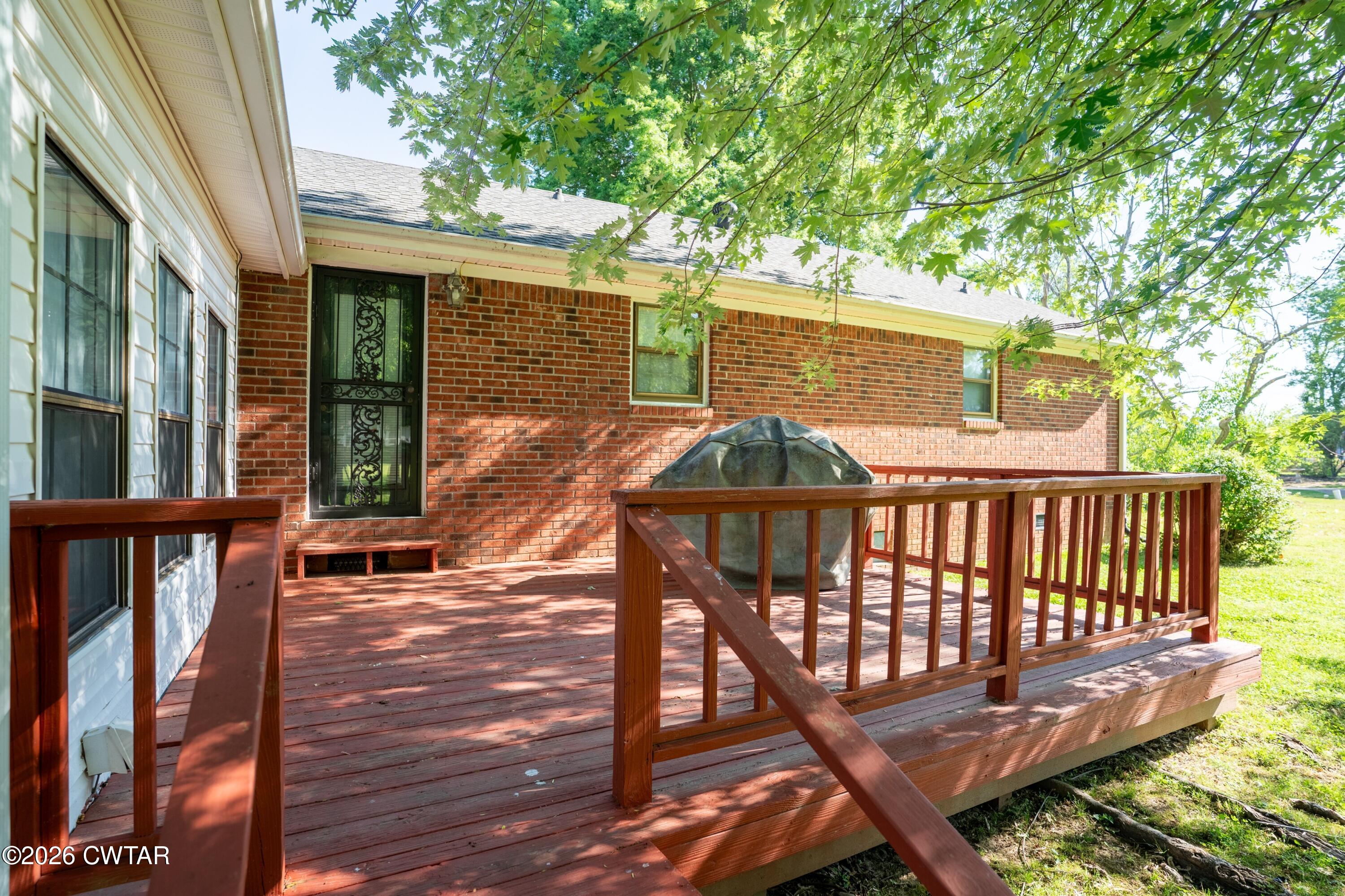 1053 Ashport Road Jackson, TN 38305 - Photo 5 of 42 a balcony with wooden floor table and chairs