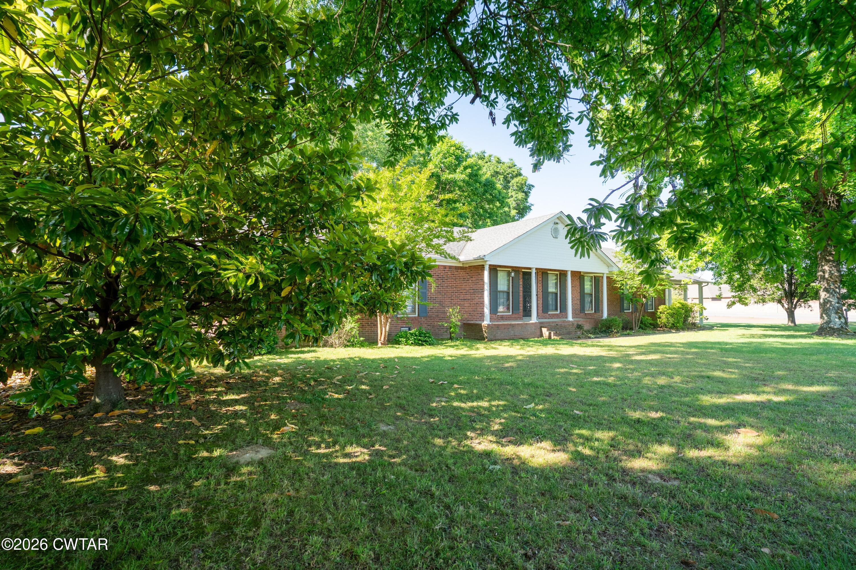 1053 Ashport Road Jackson, TN 38305 - Photo 7 of 42 a front view of a house with a garden